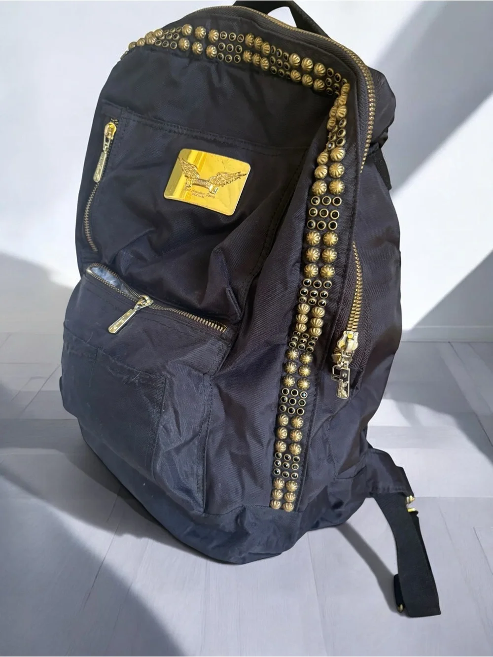 Jean Studded Backpack designed with an edgy  streetwear aesthetic.